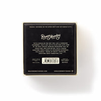 Trivial Drinking Trivia by Brass Monkey comes in a black and cream square box featuring playful drinking trivia text, misleading-category questions, branding, barcode, social handles, and website info on the back.