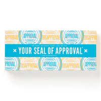 A rectangular box by Brass Monkey, decorated with blue & yellow “APPROVAL” and “DISAPPROVAL” stamps, plus a bold blue band reading YOUR SEAL OF APPROVAL. Features the Your Seal Of Approval Stamp Set inside.