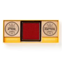 The Brass Monkey Your Seal Of Approval Stamp Set includes two wooden stamps—My Seal of Approval and My Seal of Disapproval—and a large color inkpad, all neatly boxed together.