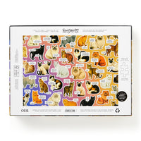 The back of the Moody Cats 1000 Piece Puzzle by Brass Monkey features illustrated, labeled cat breeds on a gradient background, along with puzzle piece outlines and brand info—all designed for a humorous touch.