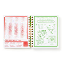 The Beyond Bored At The Holidays activity book by Brass Monkey features a spiral binding, a festive word search on the left, and a chicken-with-Santa line drawing puzzle on the right, with red and green art and text on white pages.