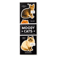 The Brass Monkey Moody Cats Magnetic Bookmark Set includes three bookmarks with illustrated cats and funny speech bubbles, all on a black background.
