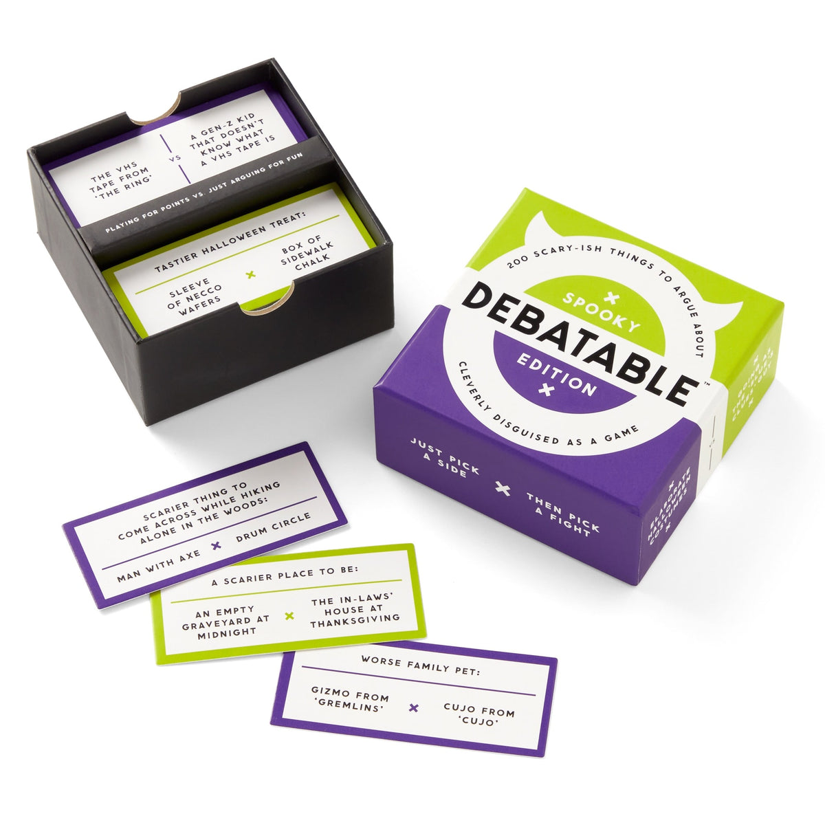 An open box of Brass Monkey's Debatable Spooky Edition reveals stacks of purple and green cards with spooky or horror debate prompts, all displayed on a white surface.