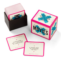 Mini Poorly Explained Movies – Y2K Edition by Brass Monkey is a card game featuring a box and stack of cards, with two visible cards showing funny movie plot hints for players to guess the film titles.