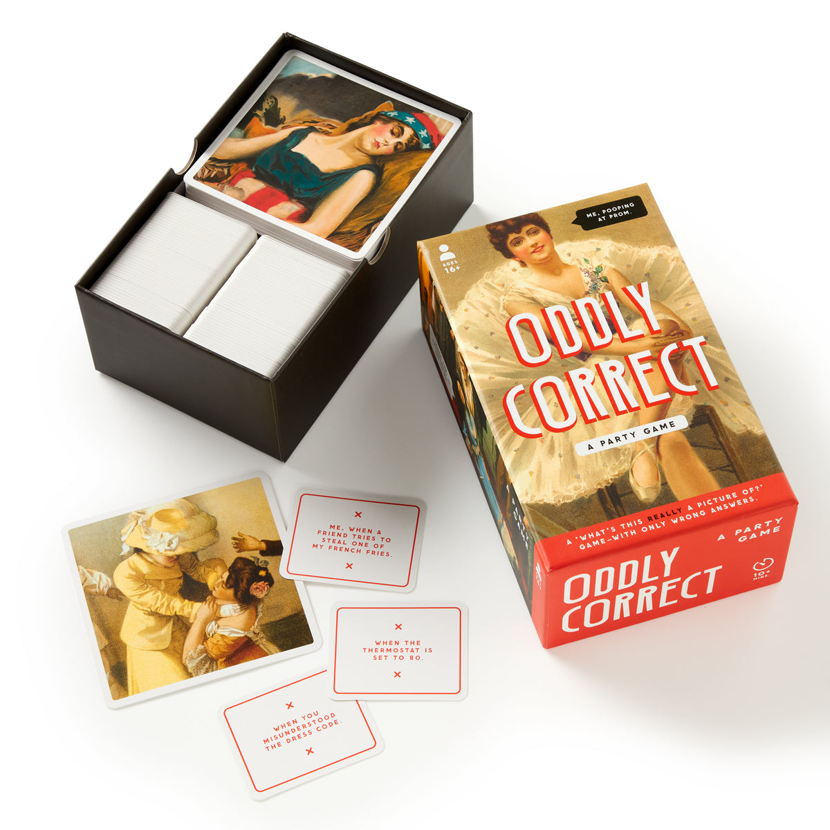 Brass Monkey’s Oddly Correct Party Game is shown with its vintage-inspired box featuring a woman and includes illustrated cards alongside white cards with red text, all arranged on a white surface.