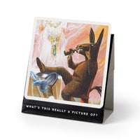 The Brass Monkey Oddly Correct Party Game features a card on a stand with a vintage donkey costume illustration and the text, “WHAT’S THIS REALLY A PICTURE OF?”—a quirky addition to your next gathering.