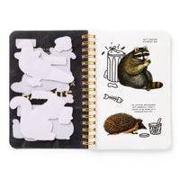 The Brass Monkey Trash Bandits Sticker Book features an open spiral design with animal-shaped sticky notes on the left and stickers of a raccoon with a trash can plus a hedgehog with food and speech bubbles on the right.