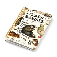 The Brass Monkey Trash Bandits Sticker Book is spiral-bound and features illustrated animals—raccoon, rat, pigeon, opossum, and mouse—with trash and a garbage can on the cover.