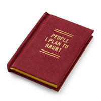 The Brass Monkey People I Plan To Haunt Tiny Diary is a small maroon notebook with gold lettering on the cover and yellow-edged pages.