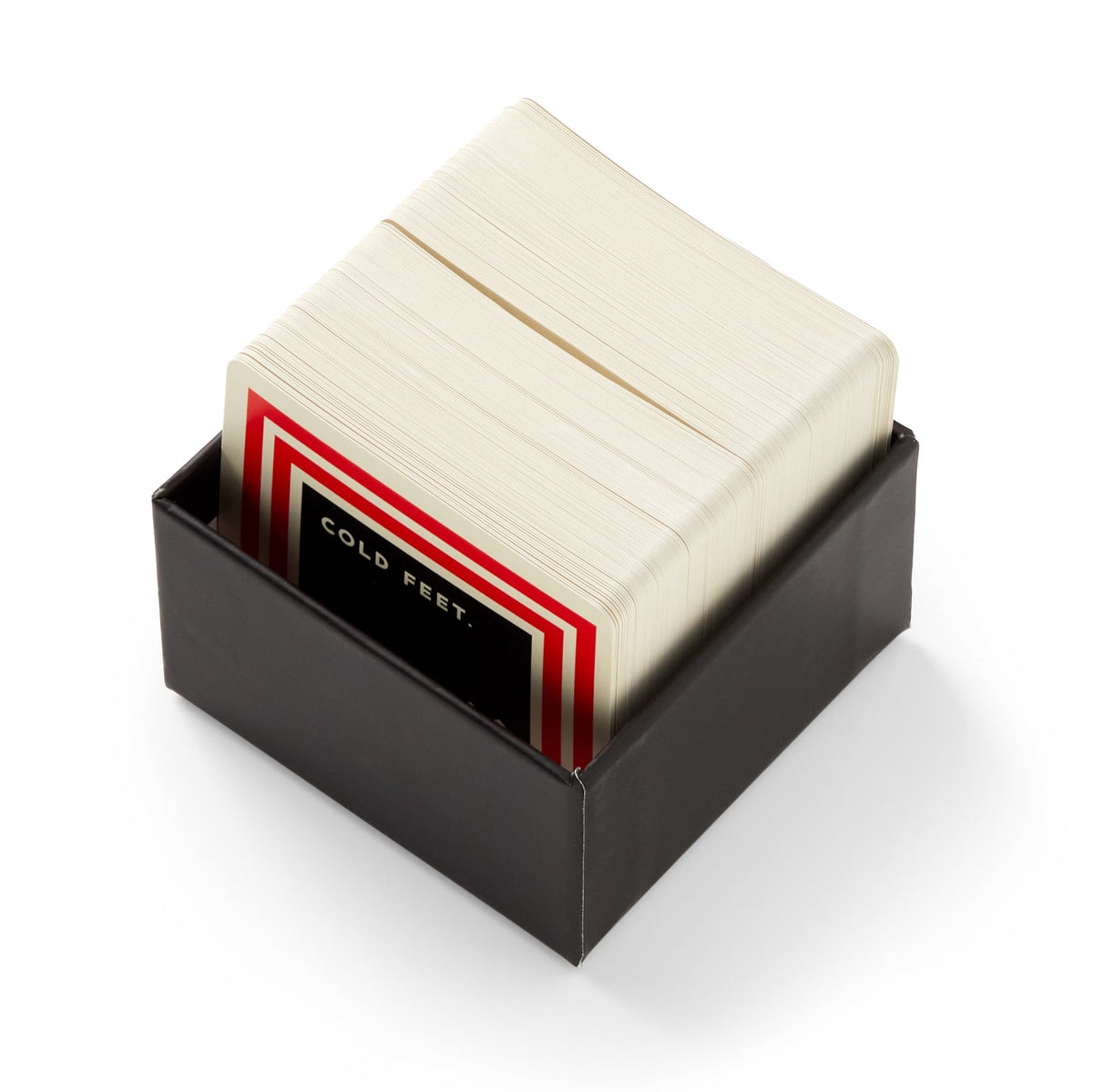 A black box from Brass Monkey containing the Frivolous Holiday Trivia card game, with the top card featuring a red, white, and black border and the words "COLD FEET." displayed on it.