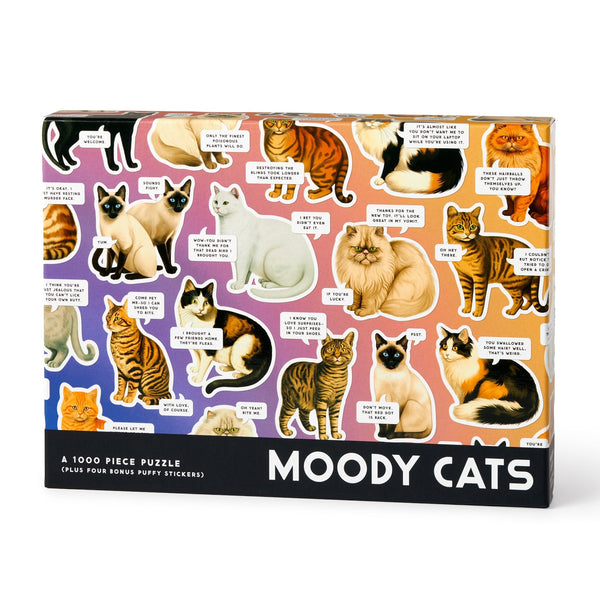 The Brass Monkey Moody Cats 1000 Piece Puzzle features illustrations of various cat breeds with expressive faces and funny captions on a vibrant gradient background.