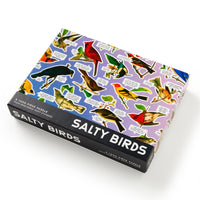 The Brass Monkey Salty Birds 1000 Piece Puzzle features vibrant illustrated birds with witty speech bubbles in a light purple box, making it both eye-catching and fun to assemble.