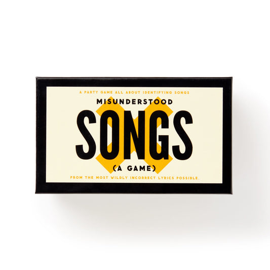 The Misunderstood Songs Game by Brass Monkey is a party game where players guess popular songs from hilariously misheard lyrics. The rectangular box features a cream label with the game’s name on it.